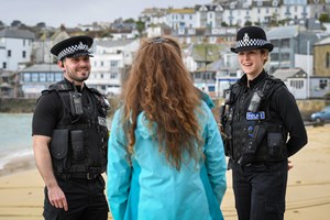 Police officers talking to woman